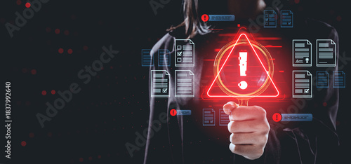 Data breach warning concept with person holding magnifying glass and red alert symbol surrounded by digital files and documents on dark background.