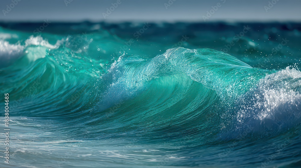 Obraz premium Bright Turquoise Ocean Wave Crashing with Sparkling Water Droplets in Sunlight