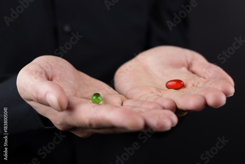 Wallpaper Mural Choose your destiny concept. Male hands holding red and green pills capsules on black background Torontodigital.ca