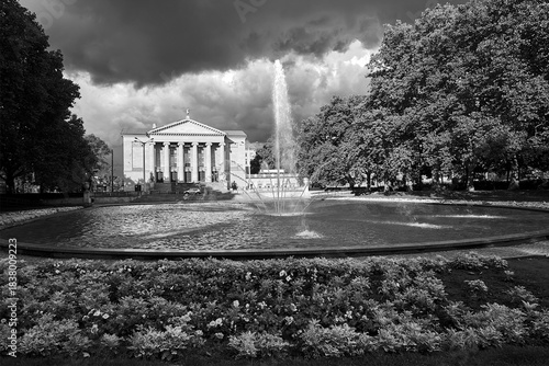 park with a fountain, flower beds and the facade of the historic opera house park with a fountain, flower beds and the facade of the historic opera house in Poznan