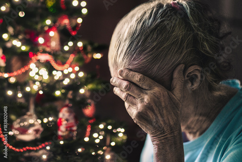 Sad on christmas. Old woman, lonely senior on winter holiday. Depressed elderly on xmas season. Dementia or depression.