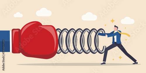 Man pushing against a large coiled spring with a boxing glove