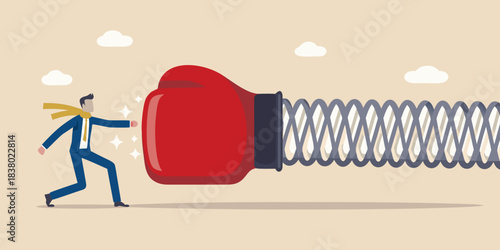 Man pushing against a large spring with a red boxing glove attached