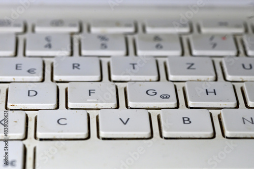 Keyboard on a dirty white laptop