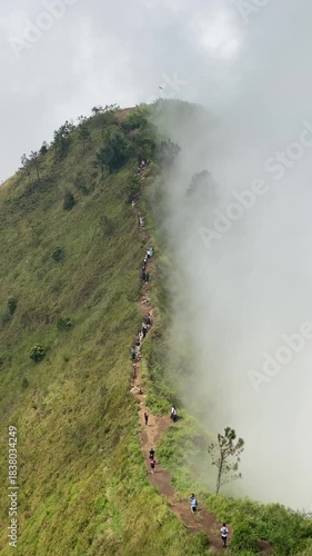4k vertical video footage of Mount Andong in the distance with half soft mist on the mountain slopes and blue sky.