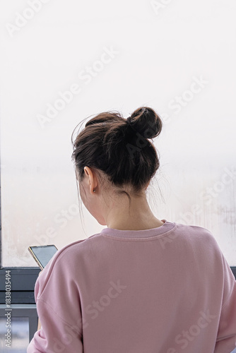 young woman ordering grocery delivery on smartphone at home