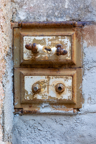 Authentic industrial and rustic charm in this old cast iron cleanout door, featuring original handles and a richly rusted surface. 