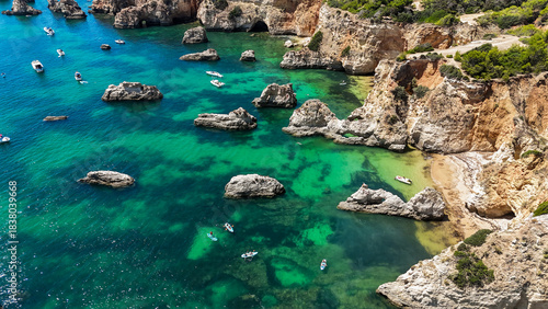 Aerial Drone View of Praia do Vau in Portimao, Portugal with Golden Cliffs, Turquoise Waters and Summer Holiday Boats