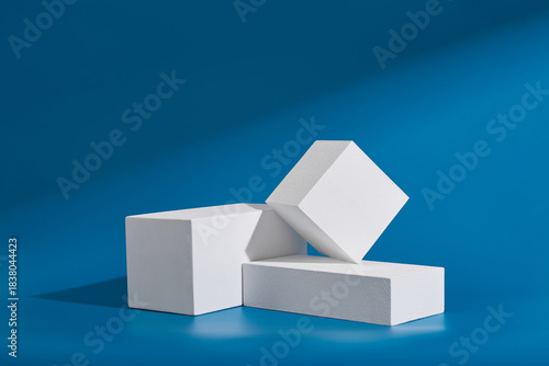 White blocks stacked against a blue background create a minimalist stage for product presentation and display