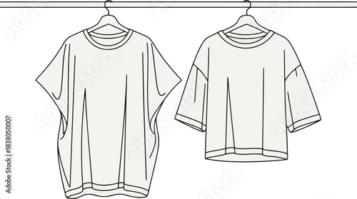 Two light colored t shirts hanging on hangers clothing
