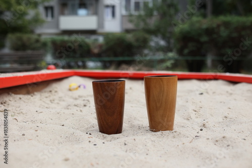 Elegant handmade wood water glass or wooden cup isolated on white background.
