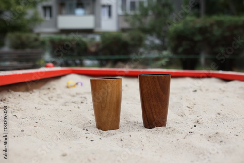 Elegant handmade wood water glass or wooden cup isolated on white background.