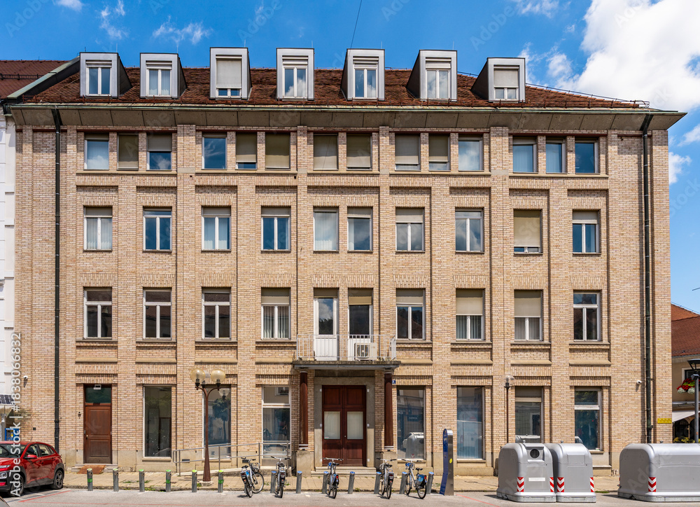 Fototapeta premium Red-brick austere building in Presernova ulica, Celje city center, Slovenia
