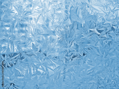 Beautiful ice pattern on window glass, close-up natural winter background