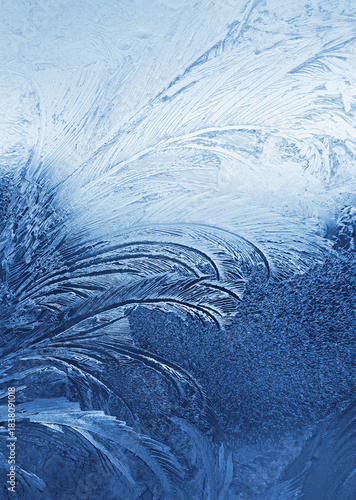 Beautiful ice pattern on window glass, close-up natural winter background