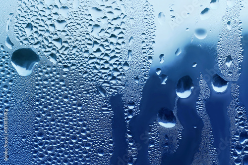 Background with water drops on window glass, close-up natural texture