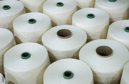 A close-up of a spool of yarn inside the factory