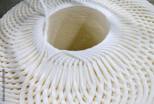 A close-up of a spool of yarn inside the factory