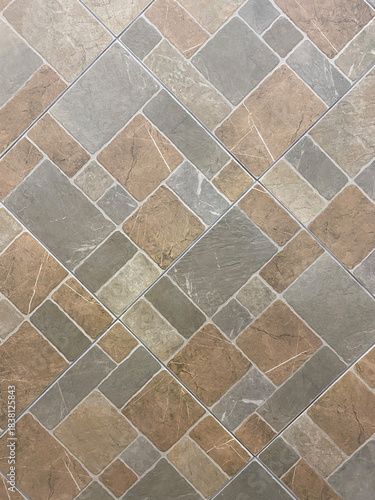 Floor tiles in a diagonal pattern with a natural stone texture, featuring a mix of gray, beige, and brown tones