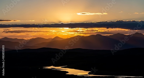 Sunset Over Mountain Range with River Reflection.