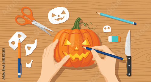 Top-down view of hands carving a jack-o'-lantern pumpkin on a wooden table with various crafting tools for Halloween.