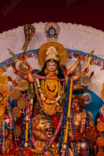 A beautifully crafted handmade colorful goddess durga idol decorated for Navratri, featuring vibrant traditional attire, intricate jewellery, and divine expressions at colorful pandal.