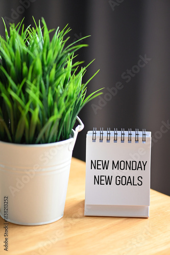 Desk Sign with New Monday New Goals — Positive Start and Weekly Planning Concept