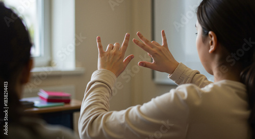 Woman using sign language while communicating in classroom setting  