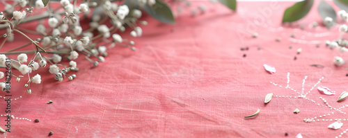 Pink floral background with white baby's breath and eucalyptus leaves. Spring flat lay banner with copy space for text
