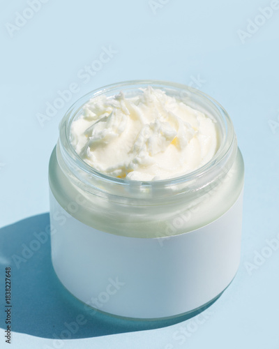 Close up of beef tallow balm texture on blue background