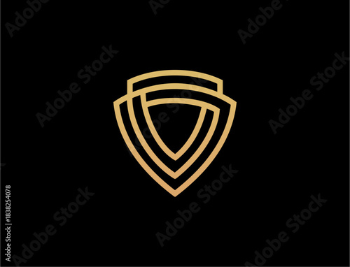 Abstract golden shield symbol on black backdrop