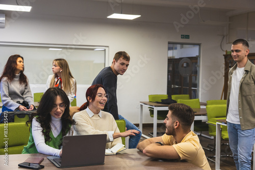 Wallpaper Mural Students Collaborating Around Laptop in Modern Classroom Torontodigital.ca