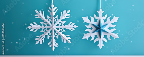 Christmas snowflake decoration hanging on blue background with festive winter mood and delicate paper cut style