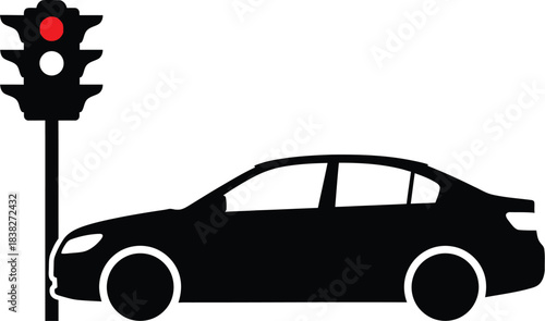 Silhouette of a car at a traffic light