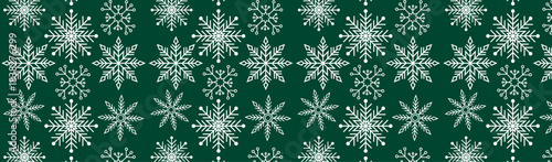 Colorful Snowflake Winter Pattern on Green Background for Christmas wrapping paper, textile prints, greeting cards, digital wallpapers, kids’ holiday projects, and winter-themed branding.