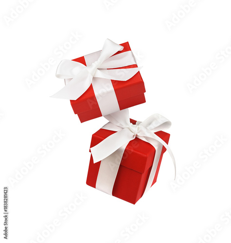 Two Red gift boxes with ribbon bows isolated on white or transparent background. Levitation.