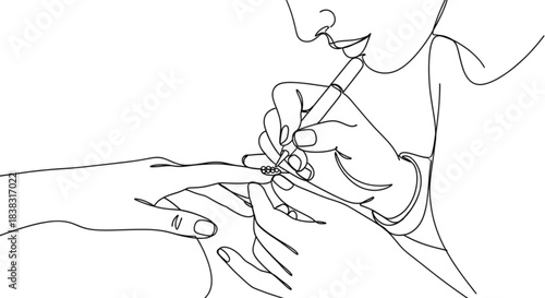 Nail artist applying rhinestones to client's fingernail in salon  