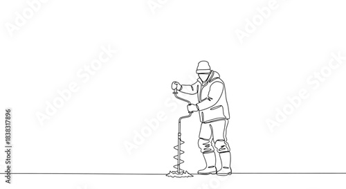 Man using ice auger while fishing on frozen lake in winter  