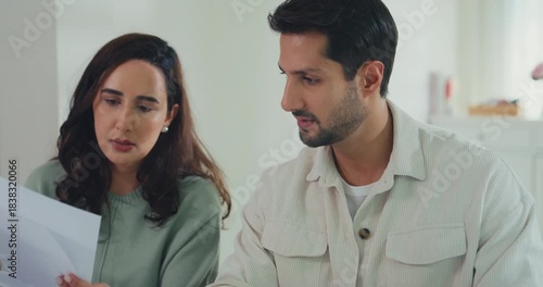 Young Latin couple male, female serious focus on laptop computer check document paper pay bills online plan budget expense in living room at home. Marriage money trouble, Family budget plan concept.