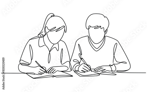 Two people writing together at a table