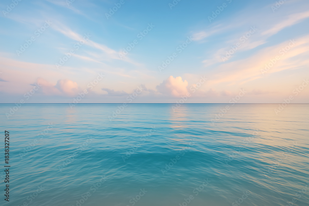 Obraz premium Tranquil ocean water horizon under pastel colored sky at dawn with soft ripples and clouds