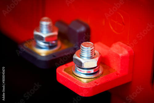 Bolt and nut in a red box, closeup of photo