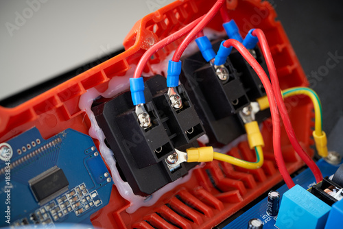 Close-up of electronic circuit board with fiber optic cables and connectors