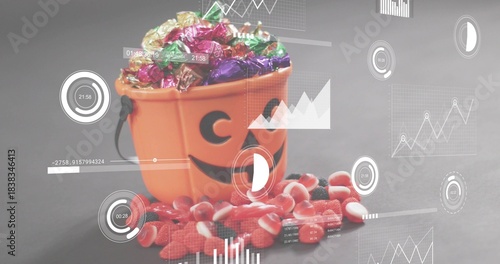 Showing orange jack-o'-lantern bucket with black handle holding foil candies on gray tabletop, HUD