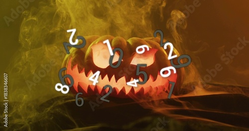 Glowing carved jack-o-lantern casting orange glow on dark cloth, with colored smoke and numerals