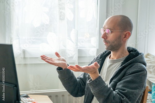 young man working at computer, frustrated programmer specialist, tense moment during coding task, modern worker solving problems, Stressful moment in digital workflow, Emotional reaction home office