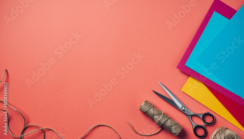 Craft Supplies Flat Lay Paper, Scissors, Twine, and Creative Workspace on Coral Background