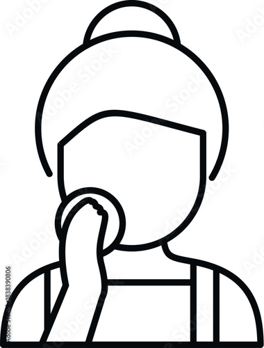 Woman cleaning her face with a cotton pad, performing a daily skincare routine