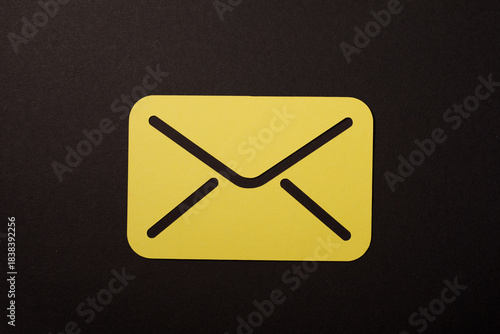 Photos Close-up of a yellow envelope icon against a contrasting black background