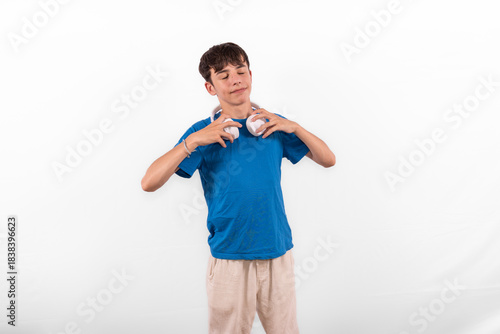 young casual dressed fun happy Gen Z influencer white male model teenage boy with wireless headphones for listening to music podcast or social media from digital device plain background studio setting